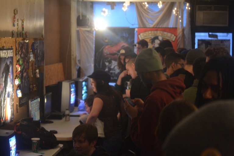 Inside the Salty Joystiq lounge in Vineland, NJ on March 1st, 2015.  Players gather around the monitors as the tournament is about to start.